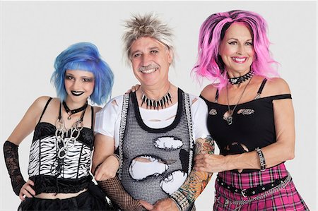 simsearch:693-06378948,k - Portrait of senior man with punk females over gray background Foto de stock - Royalty Free Premium, Número: 693-06378864