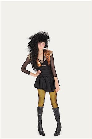 fishnet stocking - Portrait of young woman in gothic clothing over gray background Stock Photo - Premium Royalty-Free, Code: 693-06378893