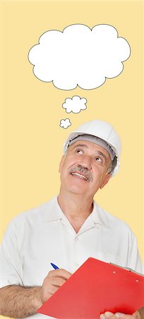 simsearch:693-06403523,k - Happy senior constructor holding clipboard while looking up over yellow background Foto de stock - Sin royalties Premium, Código: 693-06378936