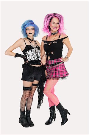 fishnet stocking - Portrait of happy senior and young punk females standing over gray background Stock Photo - Premium Royalty-Free, Code: 693-06378965