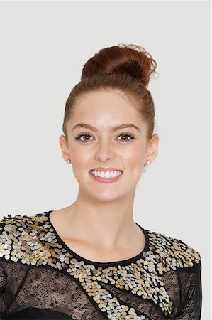 funky hairstyle women - Portrait of pretty young woman smiling over colored background Stock Photo - Premium Royalty-Free, Code: 693-06378990