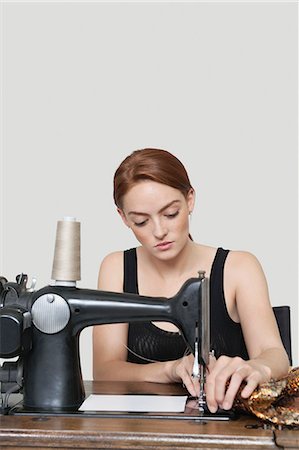 designer headshot - Young female tailor stitching cloth on sewing machine over colored background Foto de stock - Sin royalties Premium, Código: 693-06379019