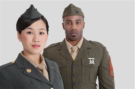 simsearch:693-06379155,k - Portrait of young, military officers in uniform, studio shot on gray background Stock Photo - Premium Royalty-Free, Code: 693-06379092