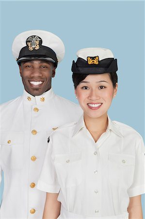 simsearch:693-06379098,k - Portrait of multi-ethnic, military officers smiling, studio shot on light blue background Stock Photo - Premium Royalty-Free, Code: 693-06379109