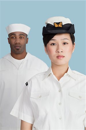 simsearch:693-06379098,k - Portrait of serious female military officer in front male sailor, studio shot on light blue background Stock Photo - Premium Royalty-Free, Code: 693-06379120