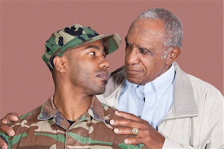 elderly father son not child - Father and soldier looking at each other, Studio Shot on brown background Stock Photo - Premium Royalty-Free, Code: 693-06379143