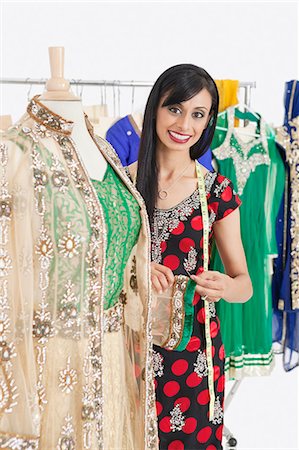 designers in studio - Portrait of an Indian female dressmaker working on traditional outfit Stock Photo - Premium Royalty-Free, Code: 693-06379284