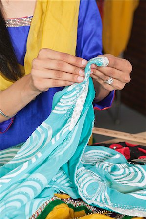 Midsection of dressmaker working on a sari Stock Photo - Premium Royalty-Free, Code: 693-06379309