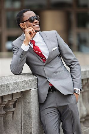 Happy young African American businessman wearing sunglasses Stock Photo - Premium Royalty-Free, Code: 693-06379466