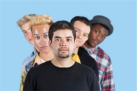 simsearch:693-06379523,k - Portrait of multi-ethnic friends standing in line over blue background Foto de stock - Sin royalties Premium, Código: 693-06379588