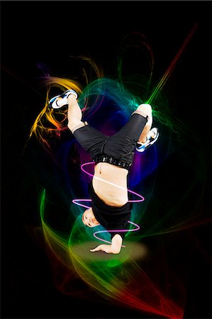 strong (human physical strength) - Break dancer on one arm over abstract background Stock Photo - Premium Royalty-Free, Code: 693-06379596