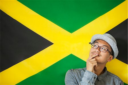 Thoughtful man against Jamaican flag Stock Photo - Premium Royalty-Free, Code: 693-06379641