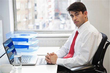 east indian businesspeople not studio not shopping not group not stress - Portrait of a confident businessman at office desk Stock Photo - Premium Royalty-Free, Code: 693-06379783