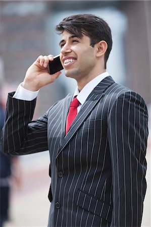 Young Indian businessman communicating on cell phone Foto de stock - Sin royalties Premium, Código: 693-06379816