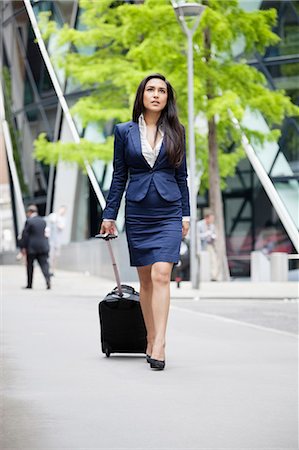 Jeune femme indienne avec des bagages en voyage d'affaires Photographie de stock - Premium Libres de Droits, Code: 693-06379899