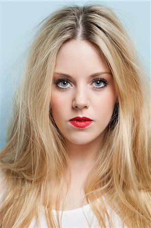 portrait, single woman, serious - Close-up portrait of beautiful young woman with blond hair and red lips Stock Photo - Premium Royalty-Free, Code: 693-06379986