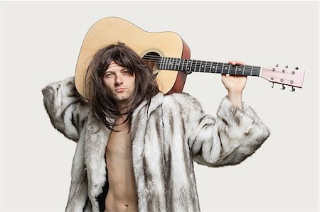 fur coat man - Portrait of young trendy man with guitar over gray background Stock Photo - Premium Royalty-Free, Code: 693-06380085