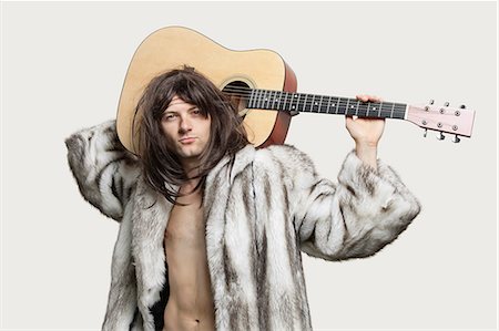 fur - Portrait of young trendy man with guitar over gray background Stock Photo - Premium Royalty-Free, Code: 693-06380085