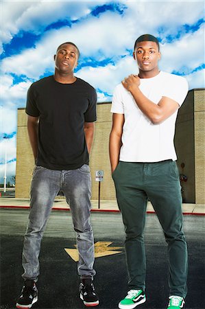 sibling portrait two people serious - Portrait of two young men in casual wear standing on road Stock Photo - Premium Royalty-Free, Code: 693-06403190