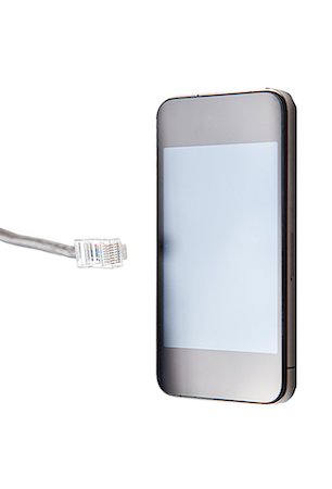 Smart phone with data cable plug over white background Foto de stock - Sin royalties Premium, Código: 693-06403352