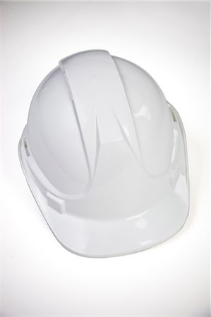 security measures - Close-up of hard hat over white background Stock Photo - Premium Royalty-Free, Code: 693-06403365