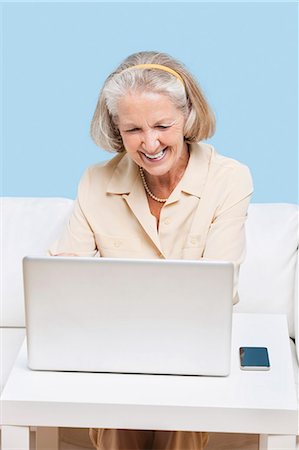 senior woman with laptop - Cheerful senior woman using laptop for video calling Stock Photo - Premium Royalty-Free, Code: 693-06403446