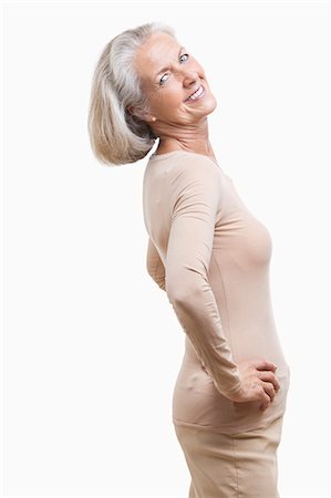 Side view of senior woman in casuals with hands on hips against white background Stock Photo - Premium Royalty-Free, Code: 693-06403472