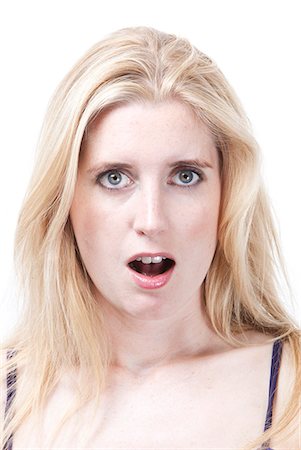 Portrait of surprised young Caucasian woman against white background Stock Photo - Premium Royalty-Free, Code: 693-06435773