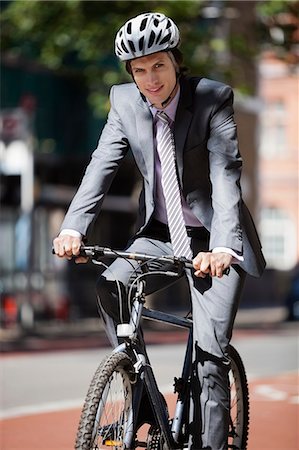 simsearch:693-06403489,k - Portrait of young businessman riding bicycle Stock Photo - Premium Royalty-Free, Code: 693-06435819