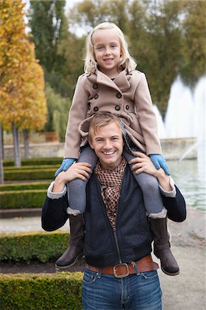 daddy shoulder ride - Portrait of father carrying daughter on his shoulders at park Stock Photo - Premium Royalty-Free, Code: 693-06435950