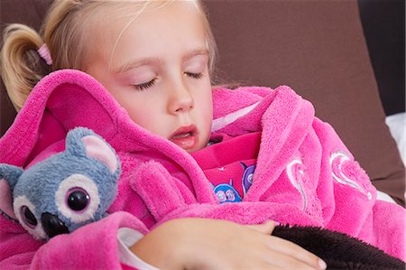 Cute little girl in pink jacket sleeping with teddy bear Stock Photo - Premium Royalty-Free, Code: 693-06435991