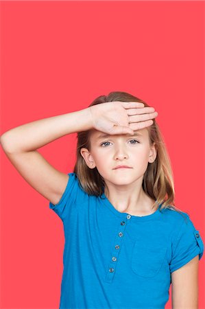 sick child - Portrait of sad girl checking self temperature against red background Stock Photo - Premium Royalty-Free, Code: 693-06436042