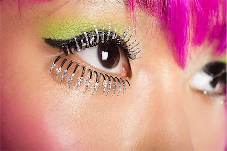 simsearch:693-06436007,k - Extreme close-up of young funky woman's face with false eyelashes Stock Photo - Premium Royalty-Free, Code: 693-06436065