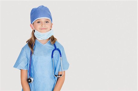 dressing up as a girl photos - Portrait of young girl in surgeon's costume against gray background Stock Photo - Premium Royalty-Free, Code: 693-06436060