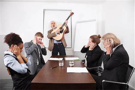 sales team - Businessman playing guitar in business meeting Stock Photo - Premium Royalty-Free, Code: 693-06497675