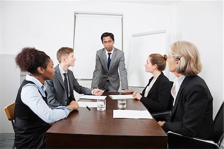 professionals whiteboard - Multiethnic businesspeople at meeting in conference room Stock Photo - Premium Royalty-Free, Code: 693-06497671