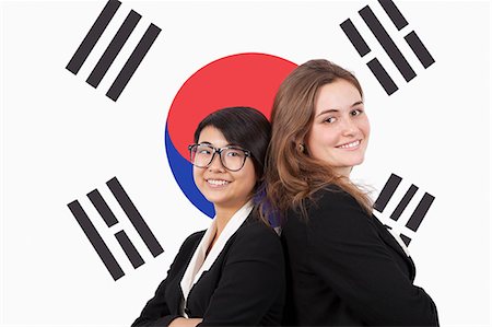 flags business - Portrait of young multiethnic businesswomen smiling over Korean flag Stock Photo - Premium Royalty-Free, Code: 693-06497717