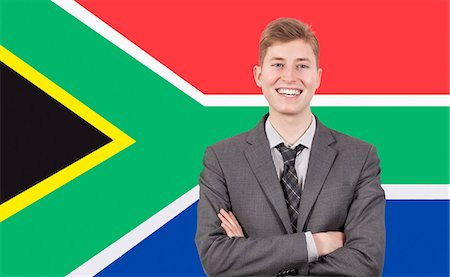 flag of south africa - Young businessman with arms crossed over South African flag Stock Photo - Premium Royalty-Free, Code: 693-06497720