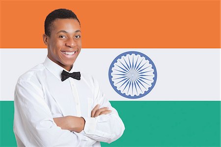 Portrait of mixed race man against Indian flag Stock Photo - Premium Royalty-Free, Code: 693-06497746