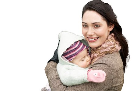 Portrait of beautiful mother holding baby girl against white background Stock Photo - Premium Royalty-Free, Code: 693-06668037