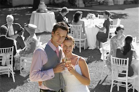 portrait of wedding party - Portrait of newly wedded couple with champagne glasses at wedding reception Stock Photo - Premium Royalty-Free, Code: 693-06668031