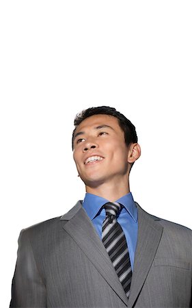 Mid-adult businessman smiling against white background Stock Photo - Premium Royalty-Free, Code: 693-06668069