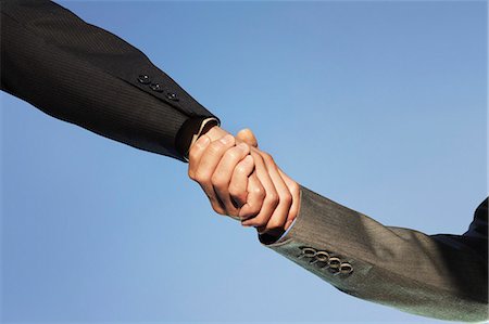 Businesspeople shaking hands against clear sky Stock Photo - Premium Royalty-Free, Code: 693-06668071