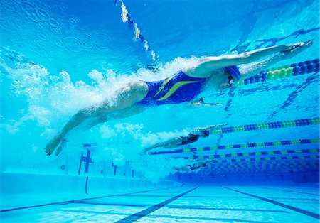 swimmer bubbles - Young female professional participants racing in pool Stock Photo - Premium Royalty-Free, Code: 693-06668088