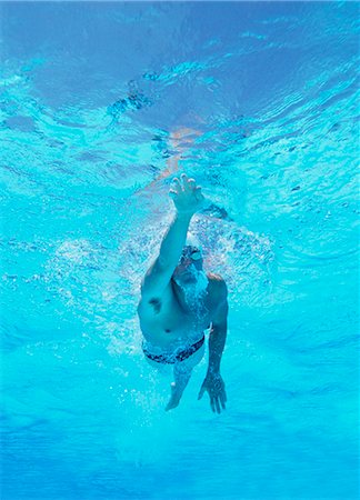 swimming - Underwater shot of professional male athlete swimming in pool Stock Photo - Premium Royalty-Free, Code: 693-06668114