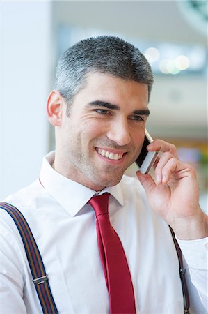 simsearch:693-06967338,k - Close-up of businessman smiling on mobile phone Stockbilder - Premium RF Lizenzfrei, Bildnummer: 693-06967338