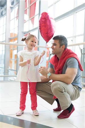 family shopping mall - Father gives young daughter heart shaped balloon Stock Photo - Premium Royalty-Free, Code: 693-06967371