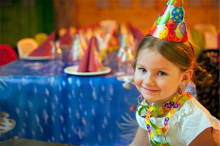 simsearch:693-06967402,k - Young girl seated at her birthday table Photographie de stock - Premium Libres de Droits, Code: 693-06967401