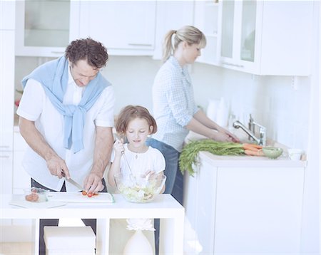 pictures of family at dinner table - Family preparing healthy meal in kitchen Stock Photo - Premium Royalty-Free, Code: 693-06967472