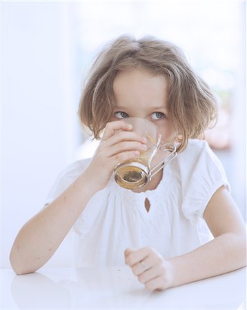Close-up view of Young girl drinking cup of tea Stock Photo - Premium Royalty-Free, Code: 693-06967493